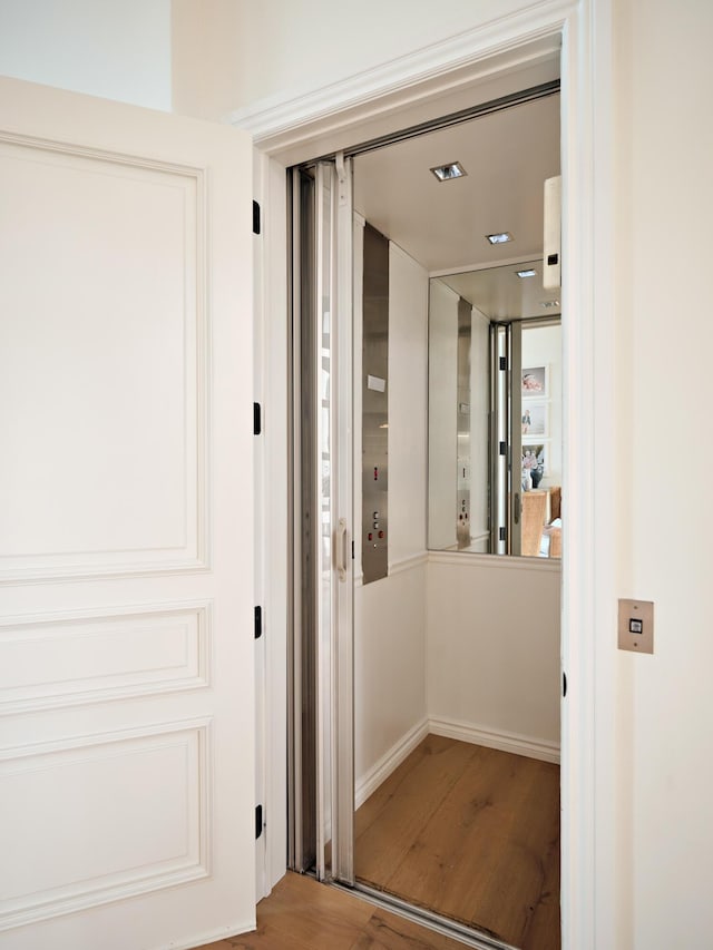 corridor featuring hardwood / wood-style flooring