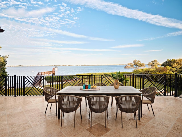 view of patio featuring a balcony and a water view