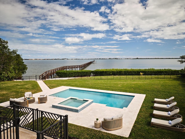 view of swimming pool with a pool with connected hot tub, fence, a yard, a patio, and a water view
