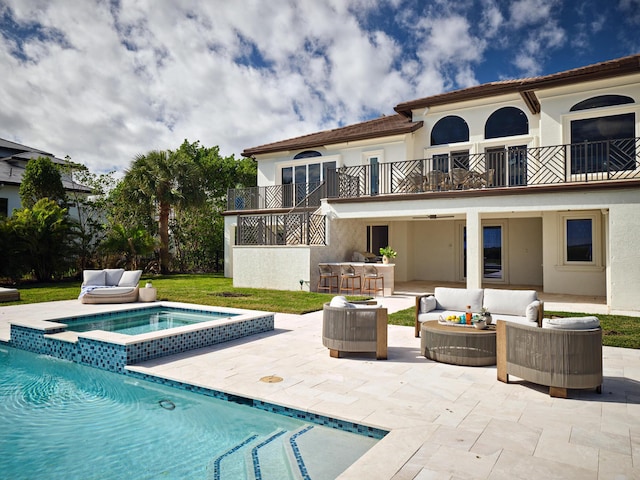 back of property with an outdoor bar, outdoor lounge area, a patio, a pool with hot tub, and a balcony