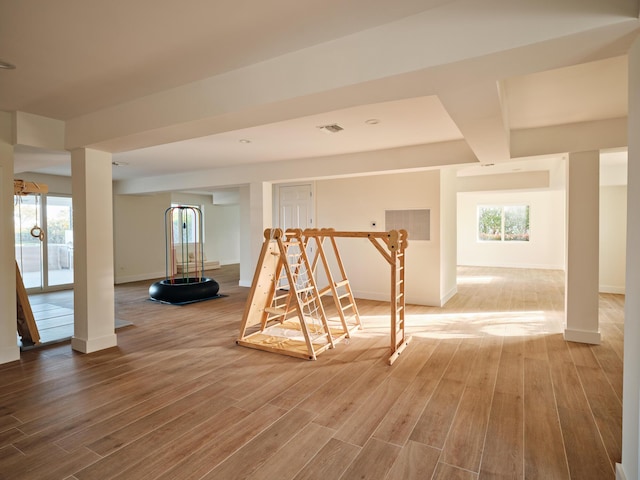 interior space with baseboards, visible vents, and wood finished floors