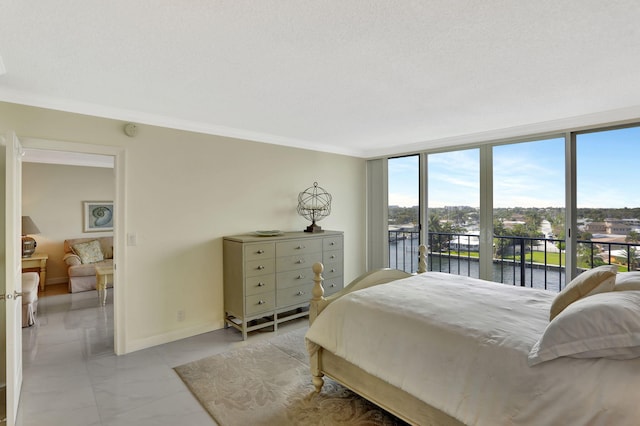 bedroom with a water view, a wall of windows, ornamental molding, and access to exterior