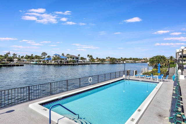 view of swimming pool with a patio and a water view