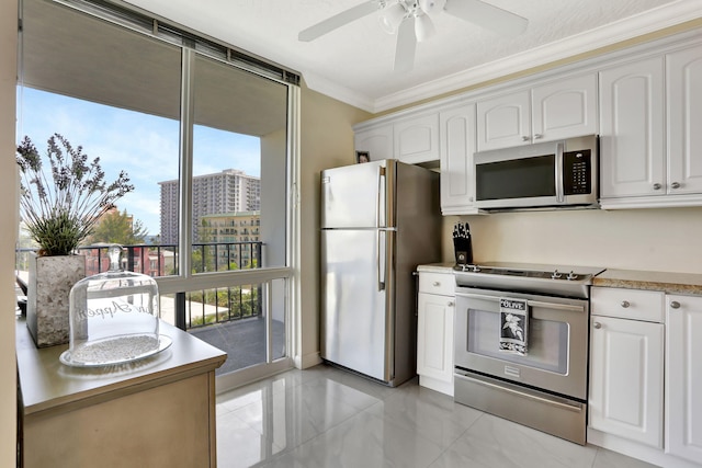 kitchen with white cabinetry, ceiling fan, stainless steel appliances, and crown molding