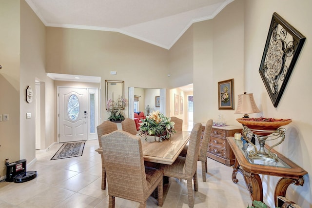 dining area with high vaulted ceiling, baseboards, crown molding, and light tile patterned flooring