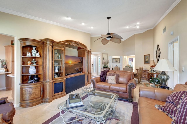 living room with ceiling fan, a high ceiling, visible vents, tile patterned floors, and crown molding