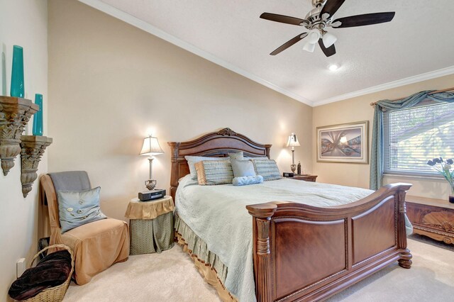 bedroom featuring crown molding, ceiling fan, vaulted ceiling, and light colored carpet