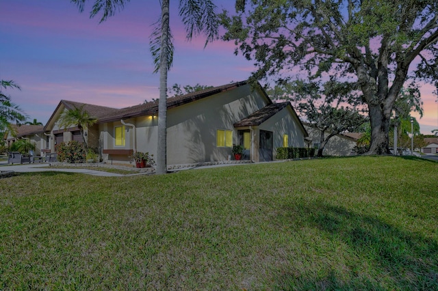 view of home's exterior with a lawn and stucco siding