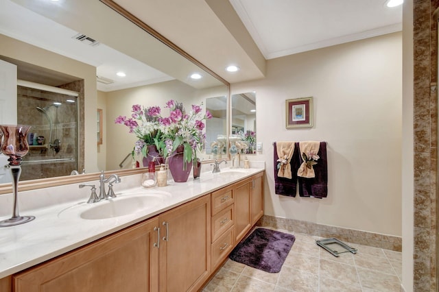 bathroom featuring double vanity, a stall shower, visible vents, crown molding, and a sink