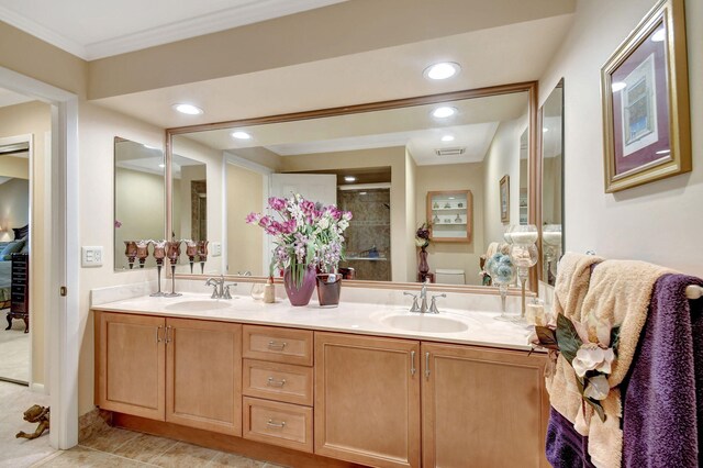 full bathroom featuring toilet, a stall shower, double vanity, and a sink