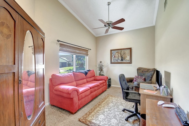 carpeted office space with ceiling fan, ornamental molding, vaulted ceiling, and baseboards