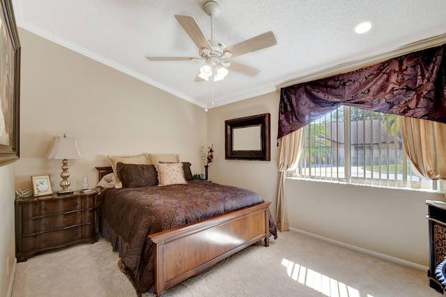 bedroom with a textured ceiling, carpet floors, a ceiling fan, baseboards, and crown molding