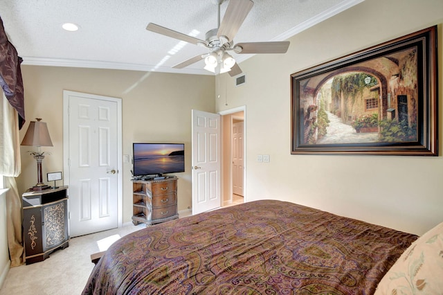 carpeted bedroom featuring a ceiling fan, a textured ceiling, visible vents, and crown molding