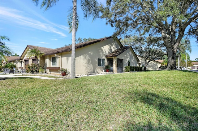 view of property exterior featuring a lawn and stucco siding