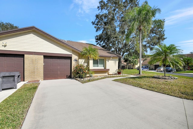 ranch-style home with a garage, driveway, brick siding, and a front yard