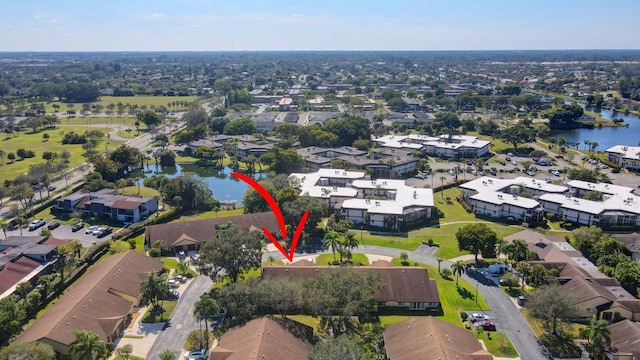 drone / aerial view with a water view and a residential view