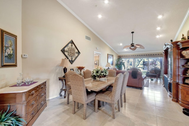 dining room with light tile patterned floors, high vaulted ceiling, visible vents, and crown molding