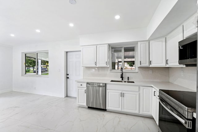 kitchen featuring sink, stainless steel appliances, and white cabinets