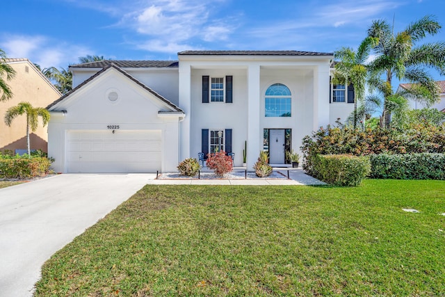 mediterranean / spanish-style home with a garage and a front yard