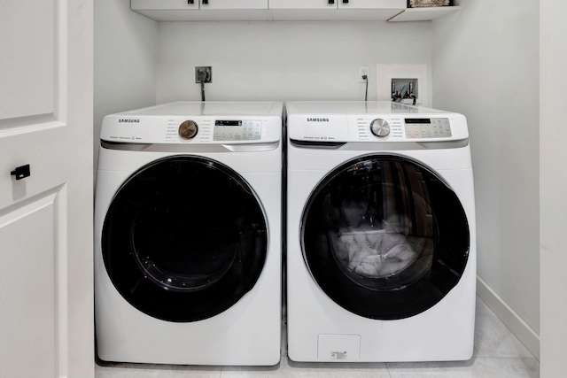 clothes washing area featuring separate washer and dryer