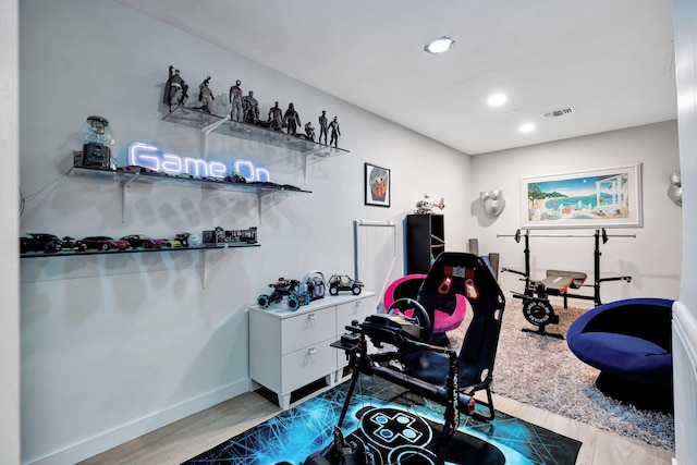 exercise area featuring light hardwood / wood-style floors