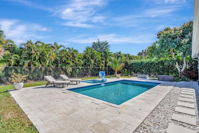 view of swimming pool with a patio area and an in ground hot tub