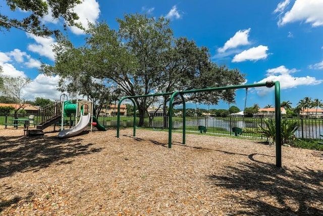 view of playground with a water view