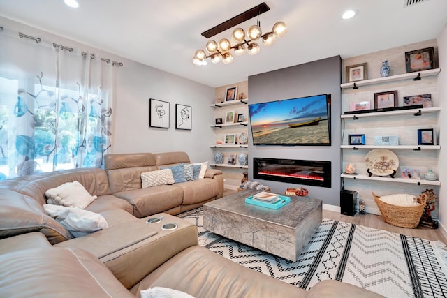 living room with an inviting chandelier and light wood-type flooring