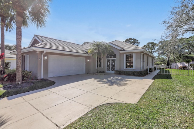 view of front facade with a garage and a front lawn