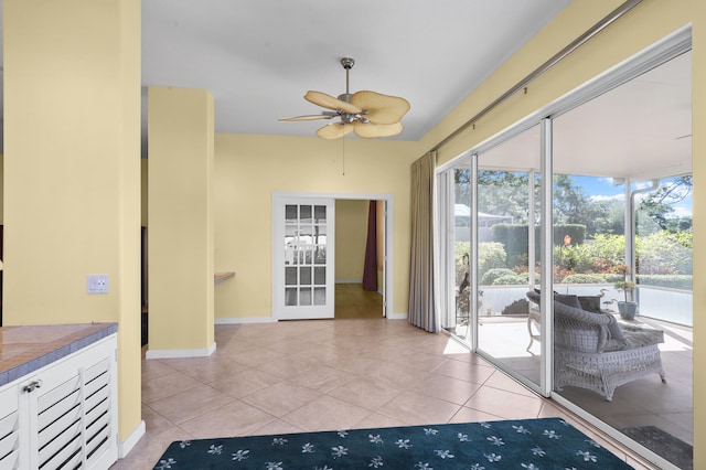 interior space with ceiling fan and light tile patterned floors