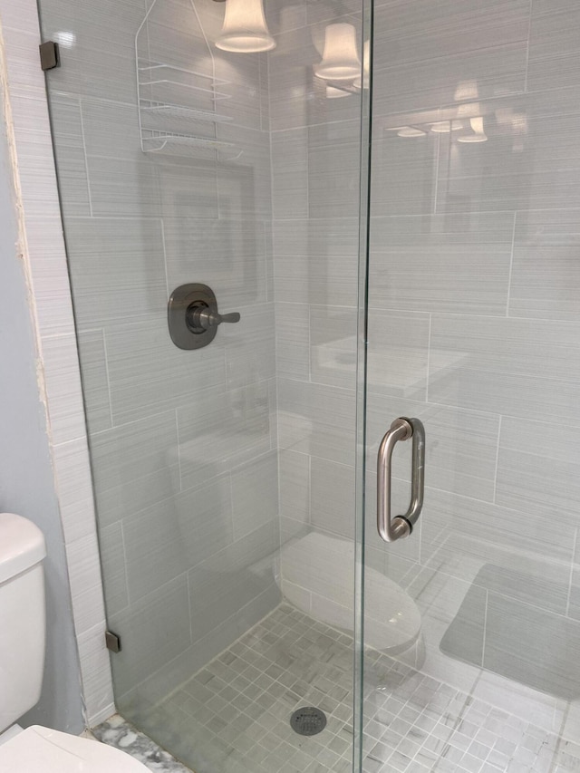 bathroom featuring toilet and walk in shower