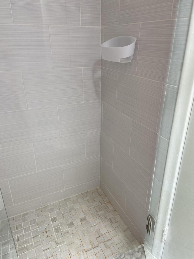 bathroom with tiled shower