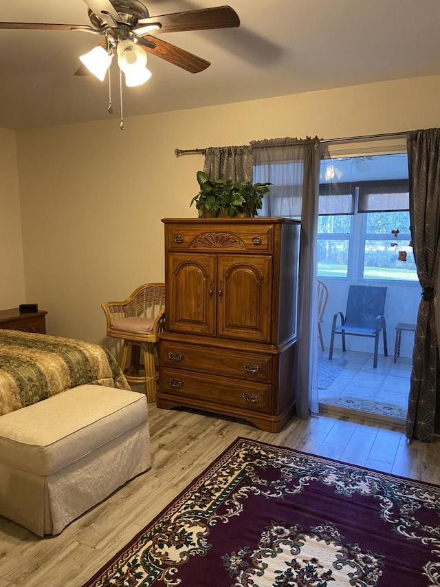 bedroom with access to outside, light hardwood / wood-style floors, and ceiling fan