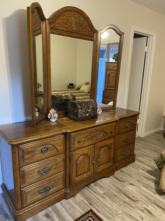 interior space with vanity and hardwood / wood-style floors