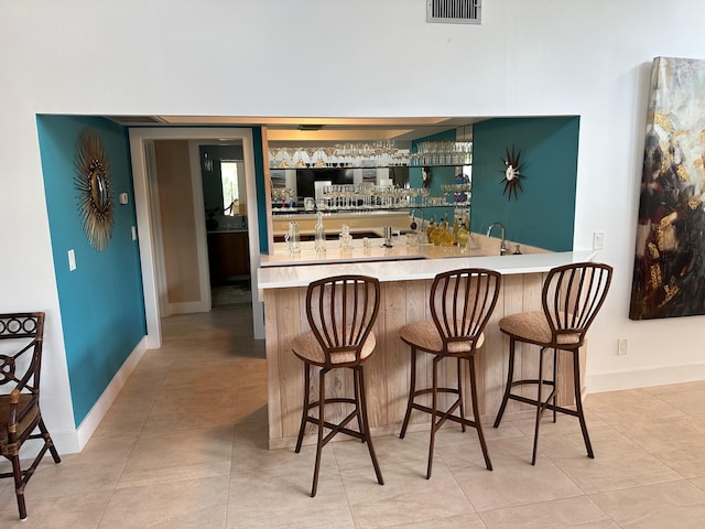 bar featuring light tile patterned floors