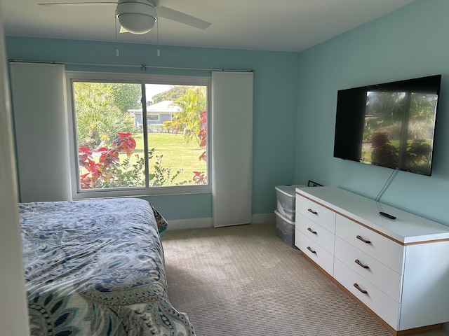 bedroom with ceiling fan and light colored carpet