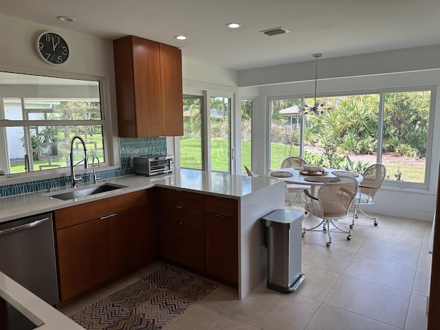 kitchen featuring hanging light fixtures, plenty of natural light, sink, and stainless steel dishwasher