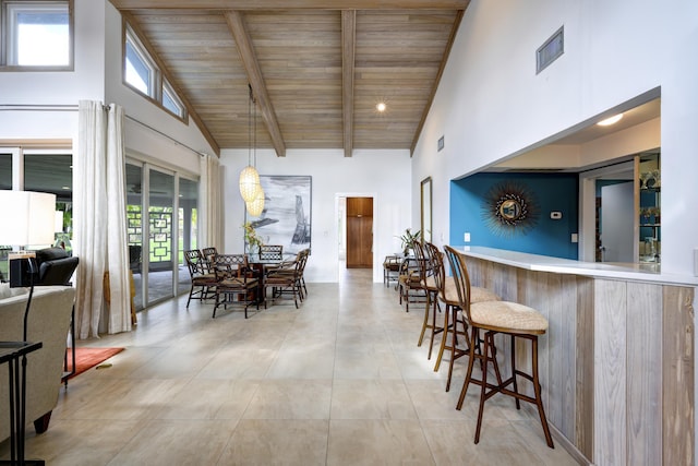 dining space with high vaulted ceiling, wood ceiling, and beam ceiling