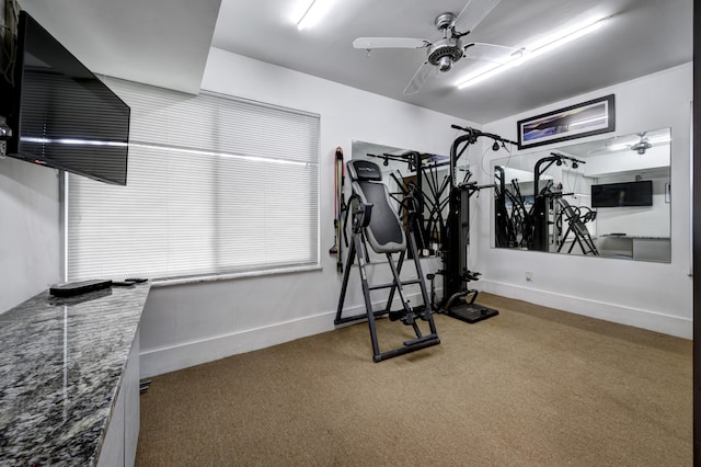 workout area with ceiling fan and carpet flooring