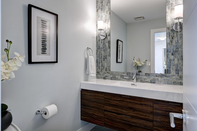 bathroom featuring vanity and decorative backsplash