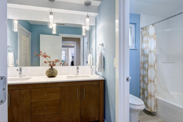 full bathroom with shower / tub combo with curtain, vanity, and toilet