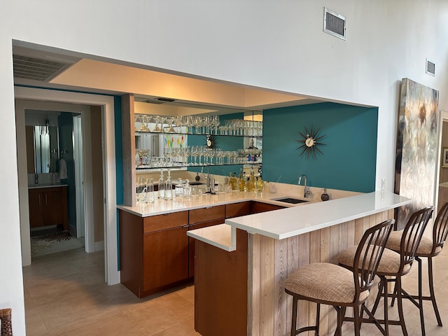 bar with light tile patterned flooring and sink