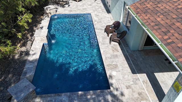 view of swimming pool with pool water feature