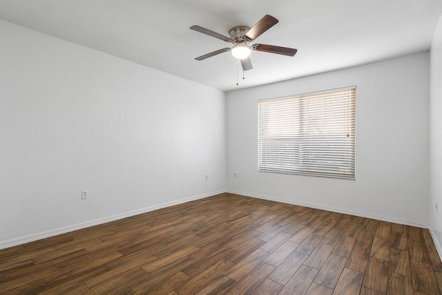 empty room with dark wood-type flooring and ceiling fan