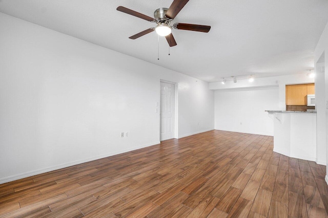 unfurnished living room with hardwood / wood-style floors and ceiling fan