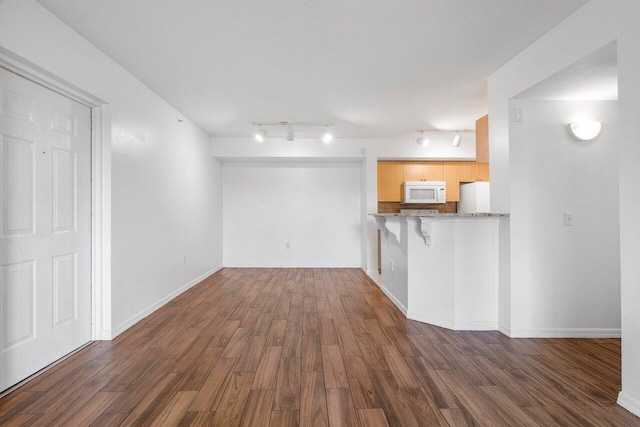 unfurnished living room featuring dark hardwood / wood-style floors