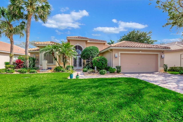 mediterranean / spanish house with a garage and a front yard