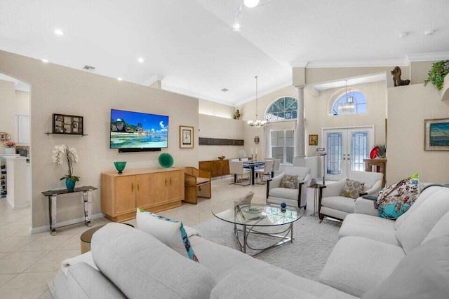 tiled living room featuring crown molding, an inviting chandelier, high vaulted ceiling, french doors, and ornate columns