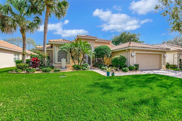 mediterranean / spanish home featuring a garage and a front yard