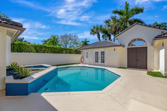 view of swimming pool with french doors, an in ground hot tub, and a patio area